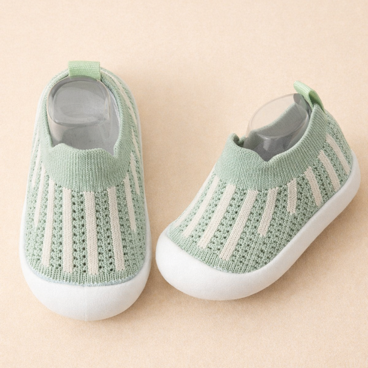 Mint green mesh sneakers with white vertical stripes and white soles.