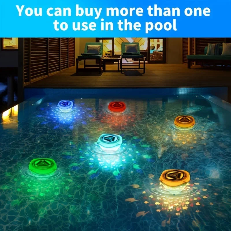 Several bath lights casting blue, red, yellow, and green patterns across a pool