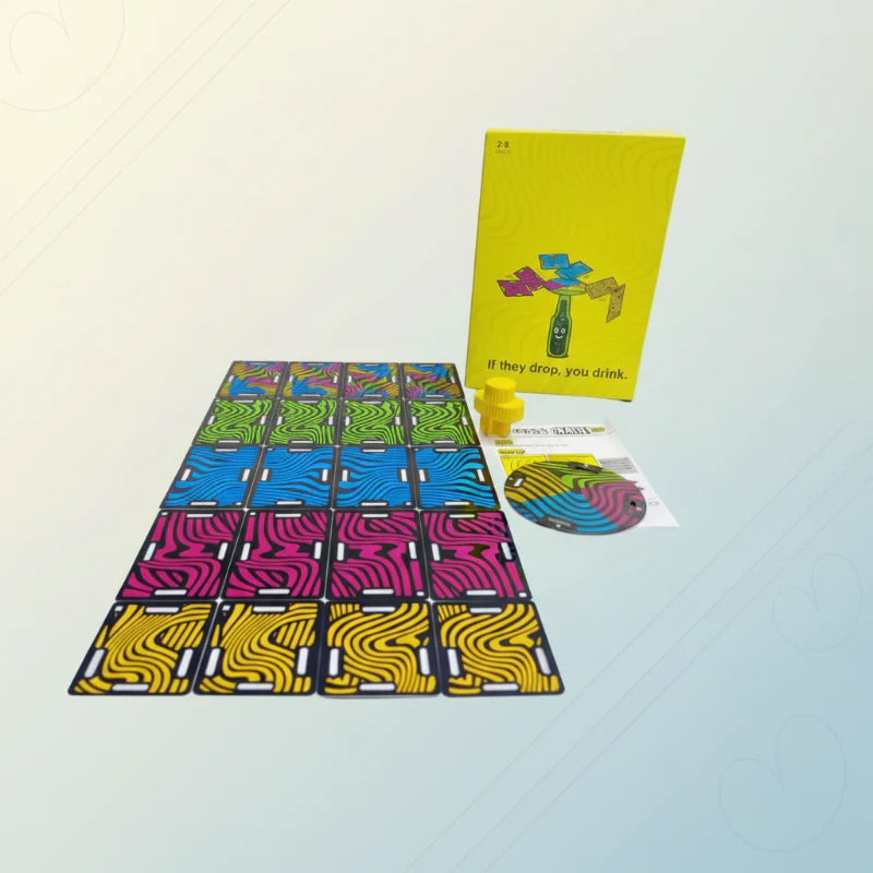Rows of colorful balance cards beside the yellow game box, round disc, and bottle stopper.