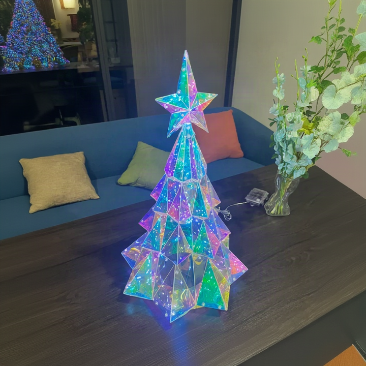 Multicolor LED Christmas tree on a wooden table in a living room