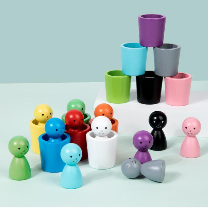 Multicolored wooden figures and sorting cups with a cup tower on a mint background