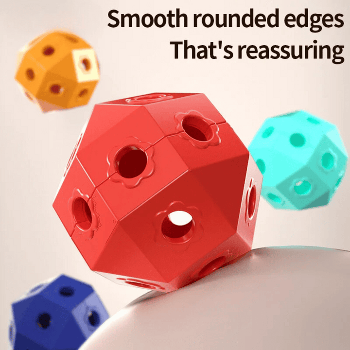 Close-up of faceted connector balls with multiple holes in red, teal, yellow, and blue