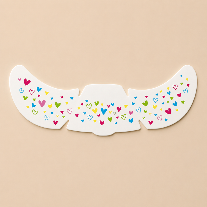 Temporary face sticker sheet with small multicolored heart patterns