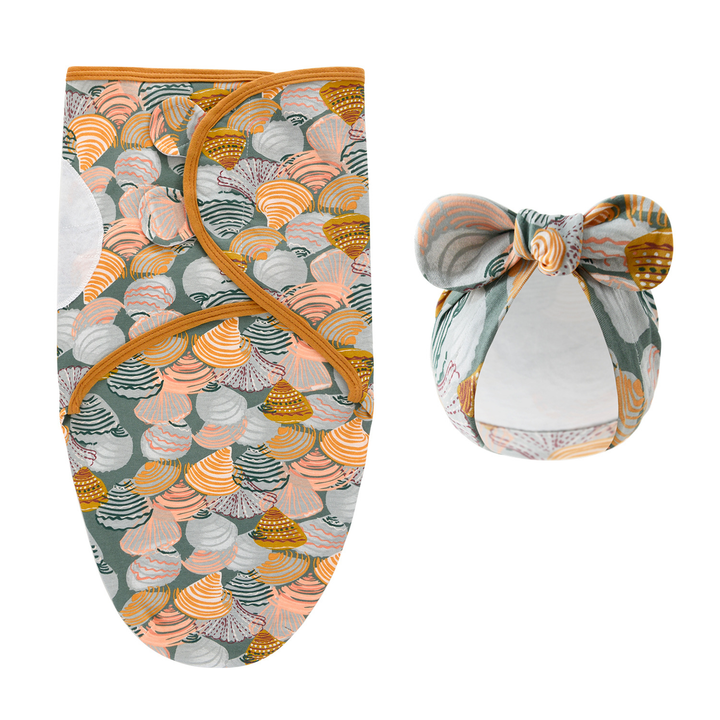 Swaddle blanket and matching bow hat with multicolored shell patterns and mustard edging