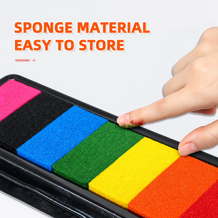 Multicolor sponge paint pad with a fingertip touching the green section
