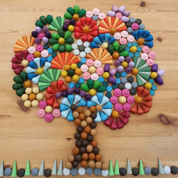 Multicolor wooden pieces arranged into a tree with a brown trunk and colorful canopy