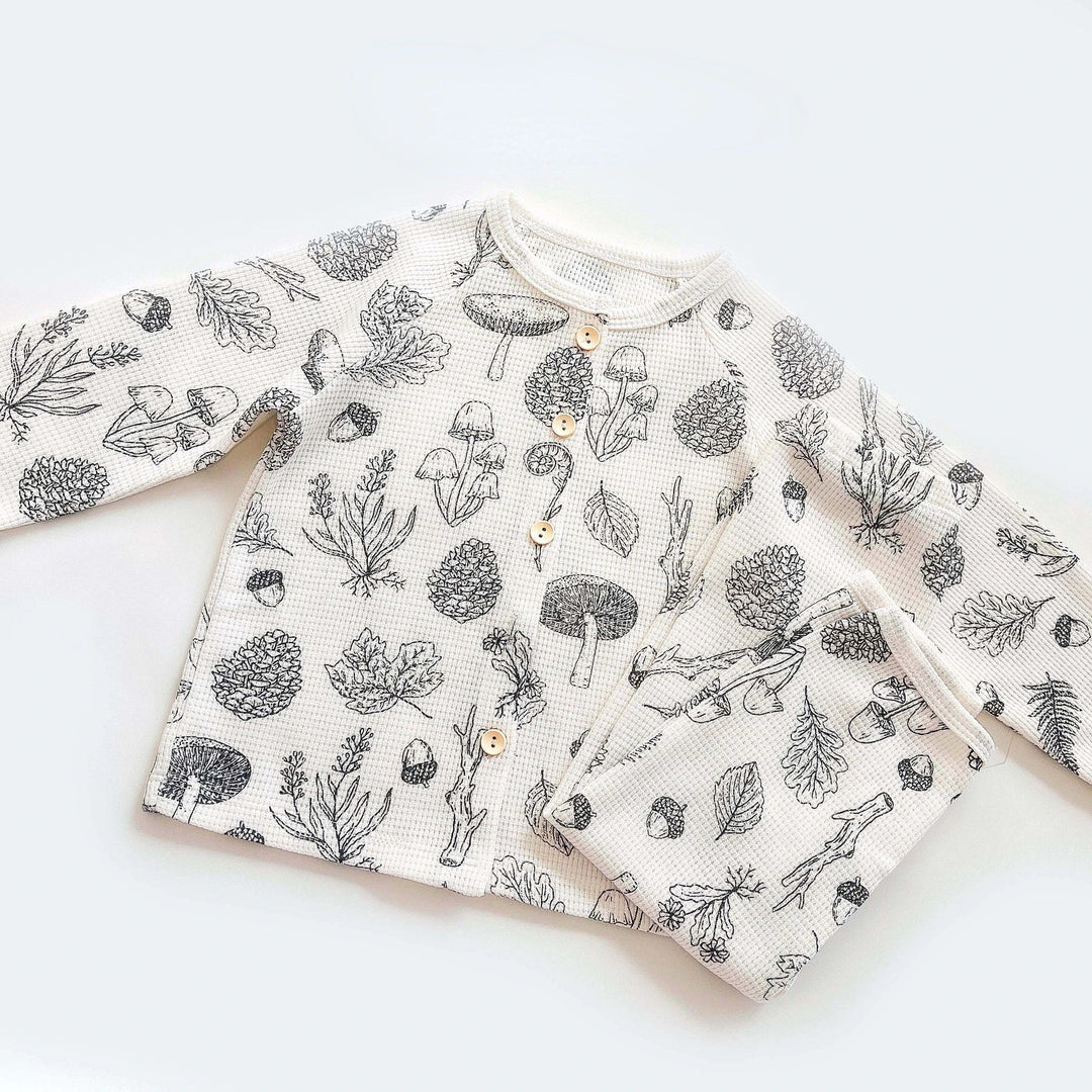 Woodland-print cotton pajamas showing the button-front top and matching pants