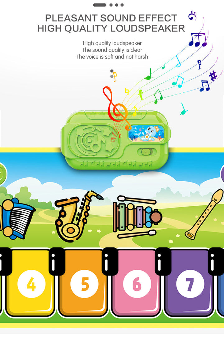 Green speaker unit above the numbered keys and instrument illustrations on a musical play mat