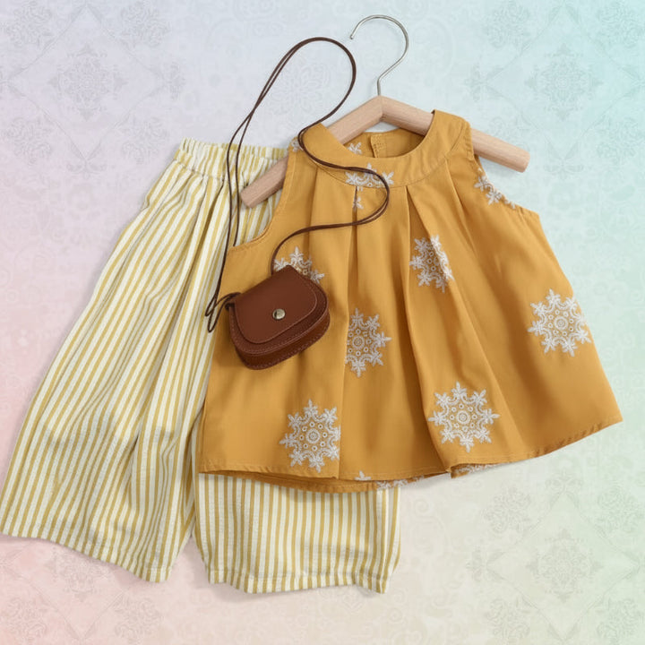 Mustard sleeveless floral top with yellow-and-white striped pants