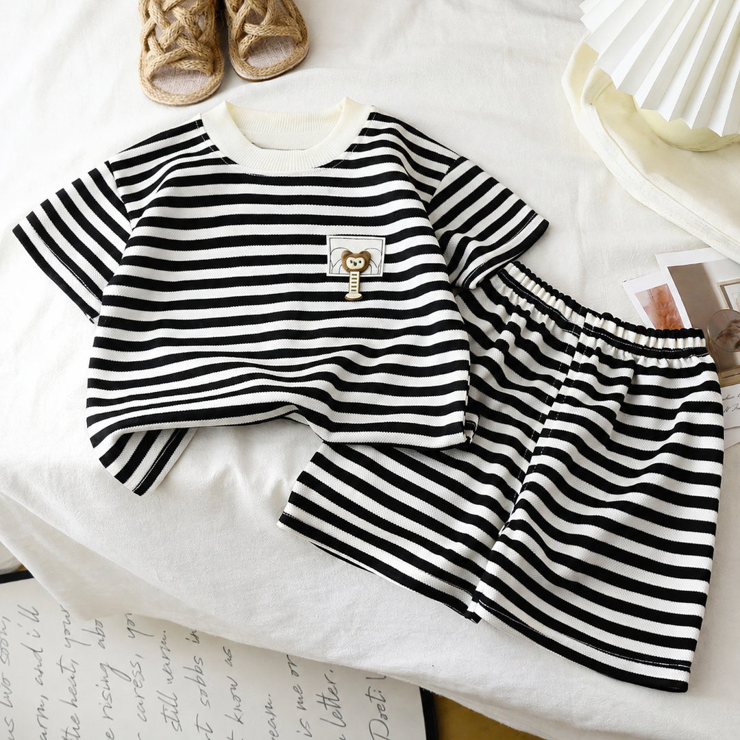 Black-and-white striped shirt and matching shorts with an elastic waistband and animal chest patch.