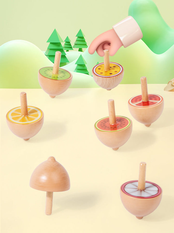 Natural wood fruit spinning tops showing fruit patterns and pointed bases