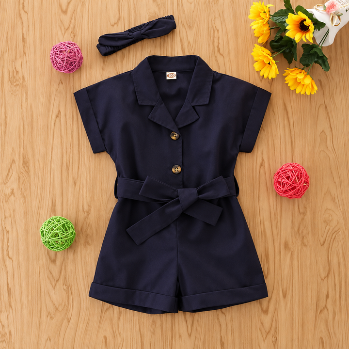 Front of the navy short-sleeve romper with a bow waist and button closure