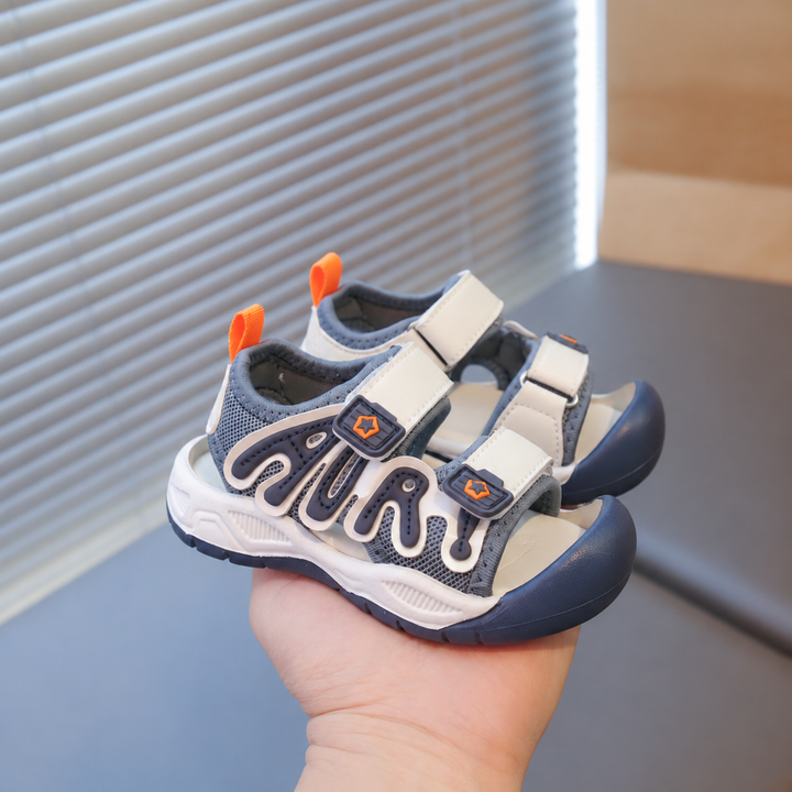 Navy and cream closed-toe sandals with two straps and orange heel loops