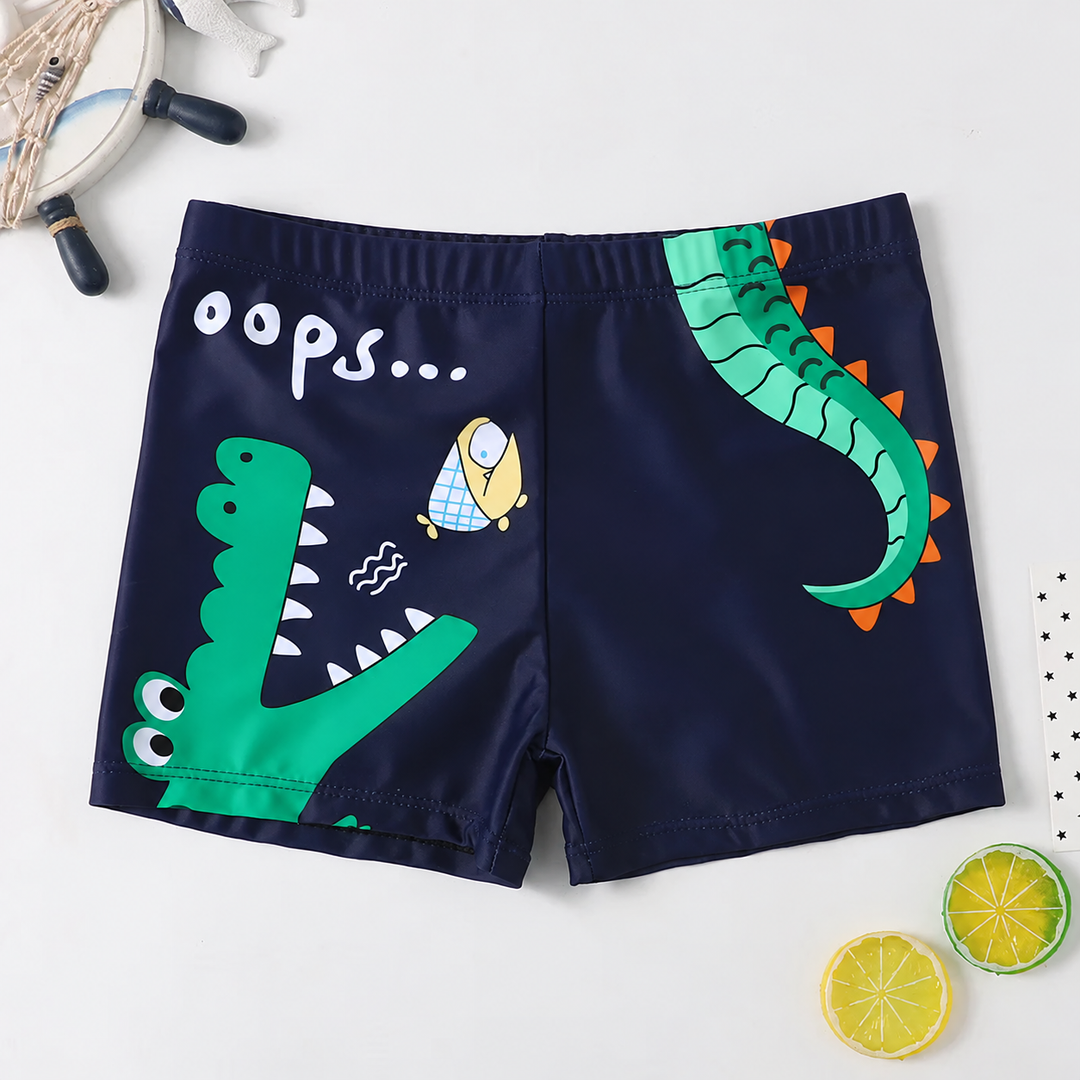 Navy swim trunks with green crocodile graphics and an elastic waistband.