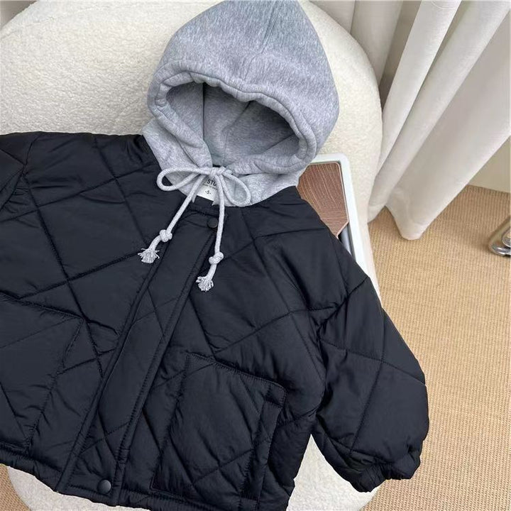 Navy blue diamond-quilted jacket with a gray hood laid on a chair.