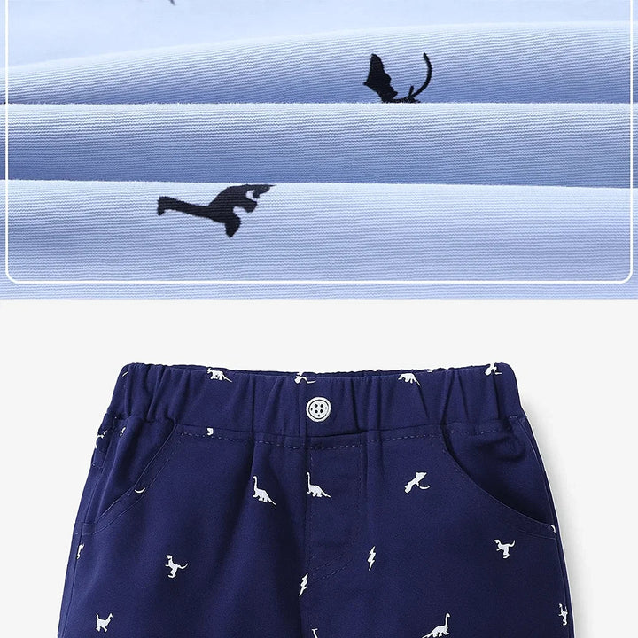 Close-up of dinosaur-print fabric above navy shorts with an elastic waistband