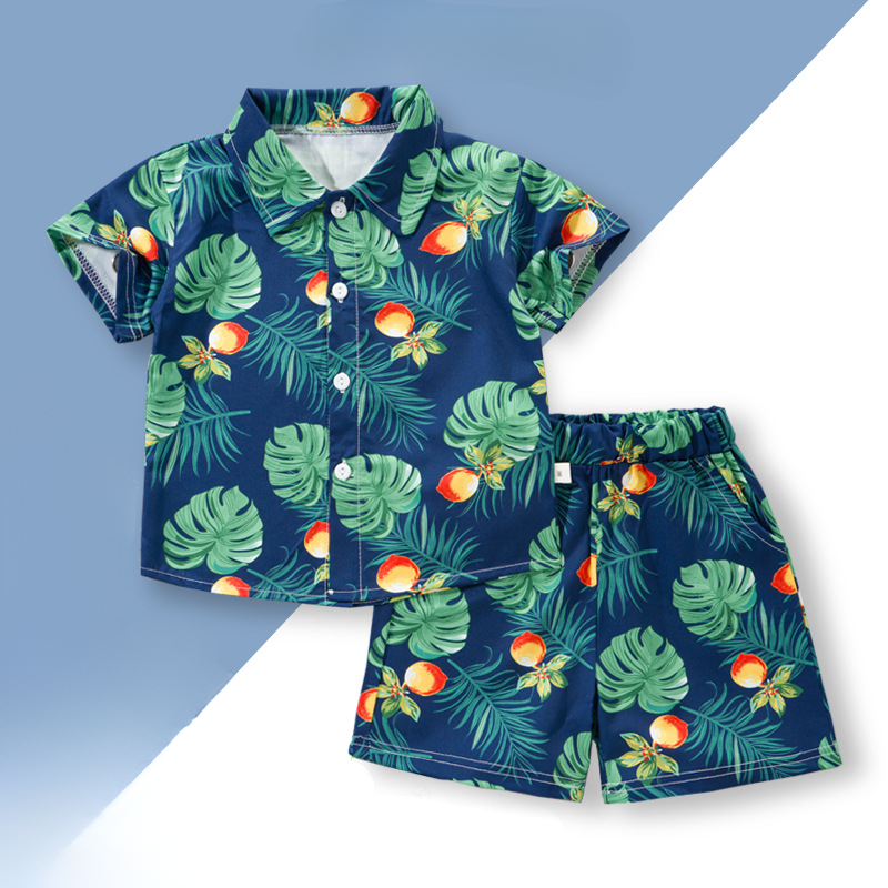 Navy shirt and shorts with green tropical leaves and orange fruit motifs