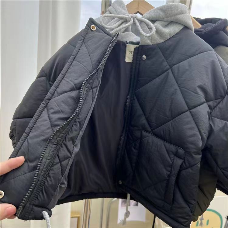 Blue quilted jacket held open to show its lining, zipper and front fastening details.