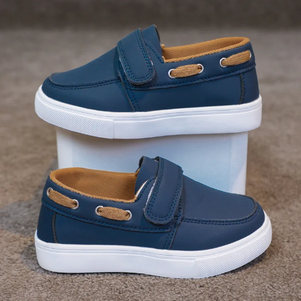 Side views of navy blue loafer sneakers with white soles