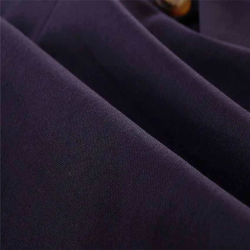 Navy romper fabric shown in close-up with folds and visible texture