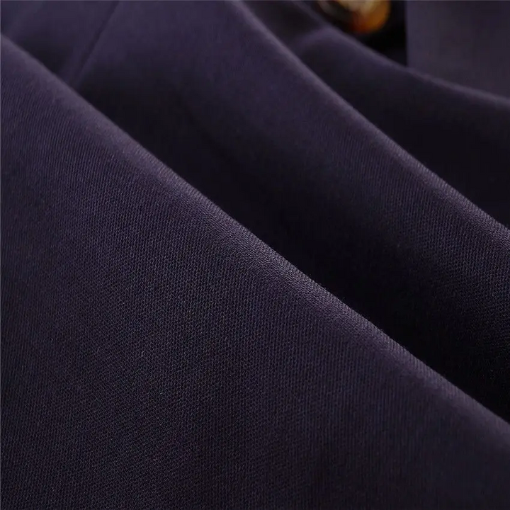 Navy romper fabric shown in close-up with folds and visible texture