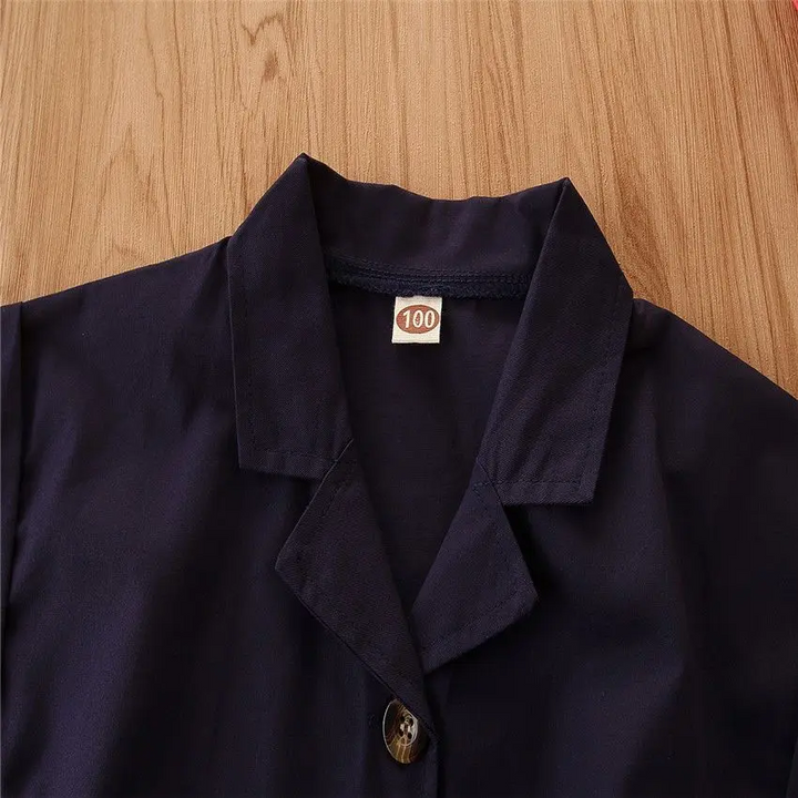 Navy romper neckline showing the notched collar and top button