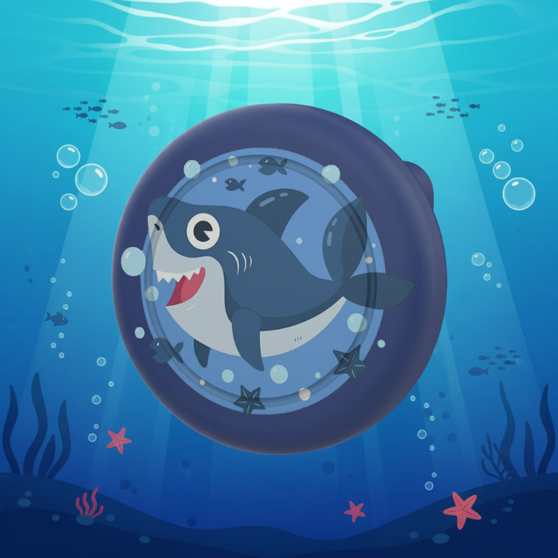 Dark blue AirTag brooch case with a smiling shark design