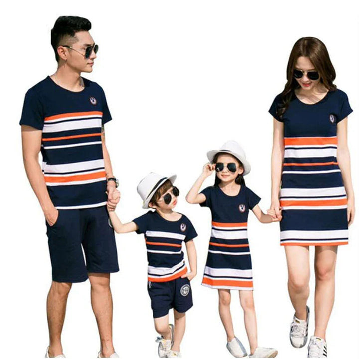 Family of four in matching navy, white, and orange striped T-shirts and dresses
