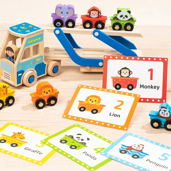 Animal vehicles on a blue wooden carrier truck beside numbered animal matching cards.
