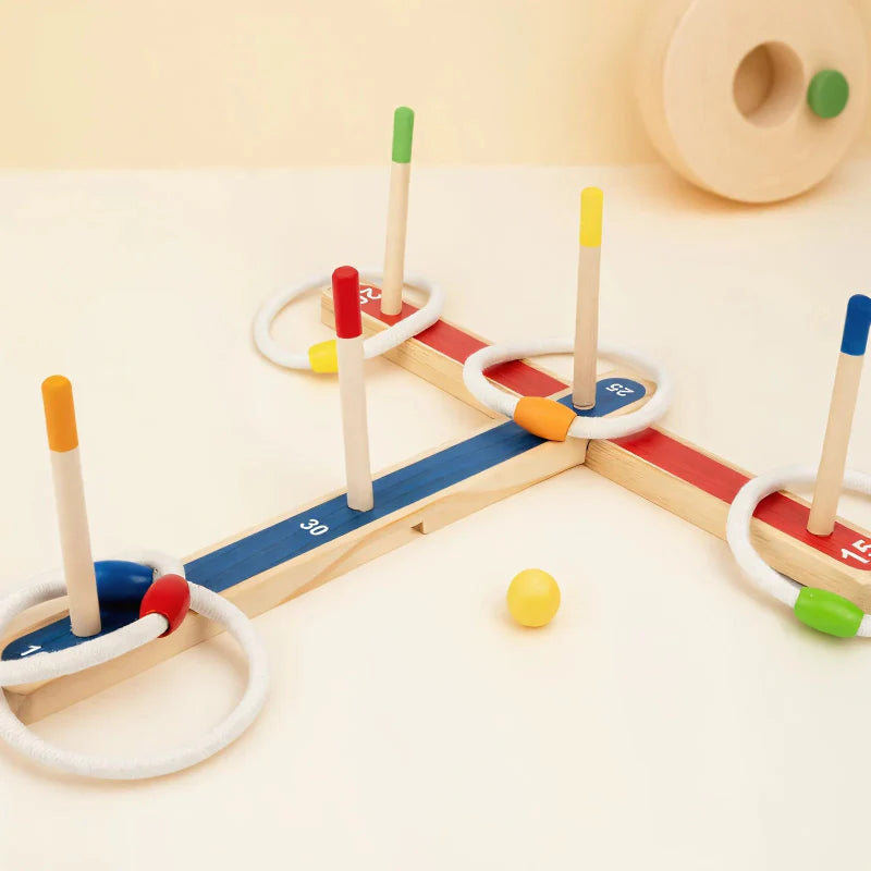 Angled view of the wooden ring toss base with numbered arms, colorful peg tips, and white rings.