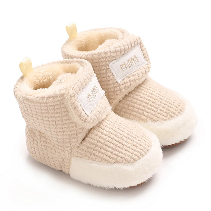 Oatmeal baby boots with waffle-textured uppers, plush cuffs and wraparound straps