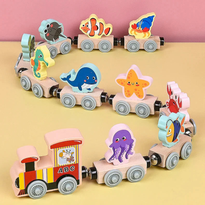 Wooden magnetic ocean train with colorful sea animal cars on a pink and yellow background