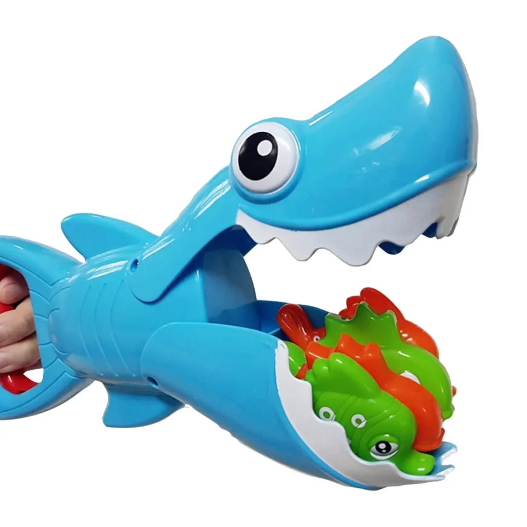 Blue shark bath toy holding green and orange fish in its open mouth