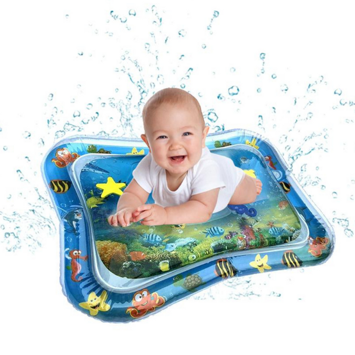 Baby lying on a blue ocean-themed water mat with colorful sea-animal shapes