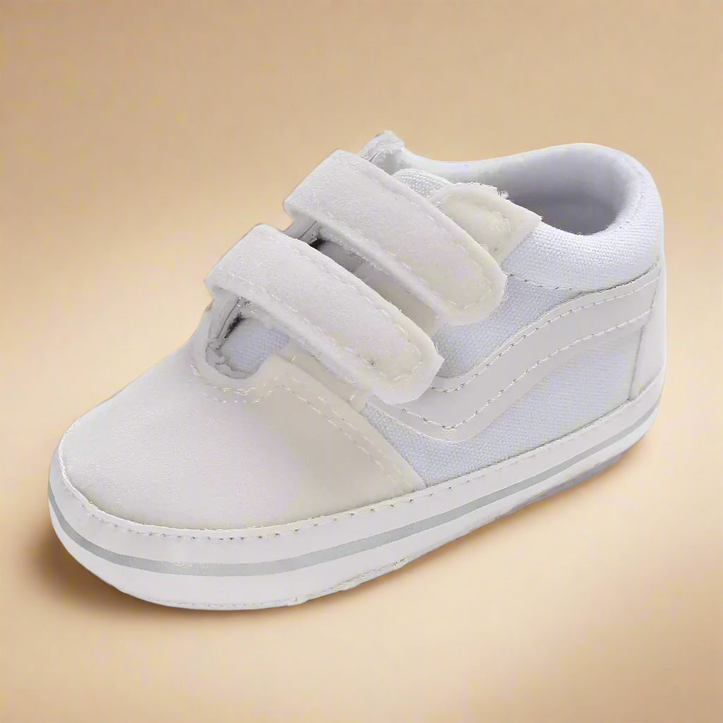 Off-white baby sneaker with two hook-and-loop straps and contrast stitching