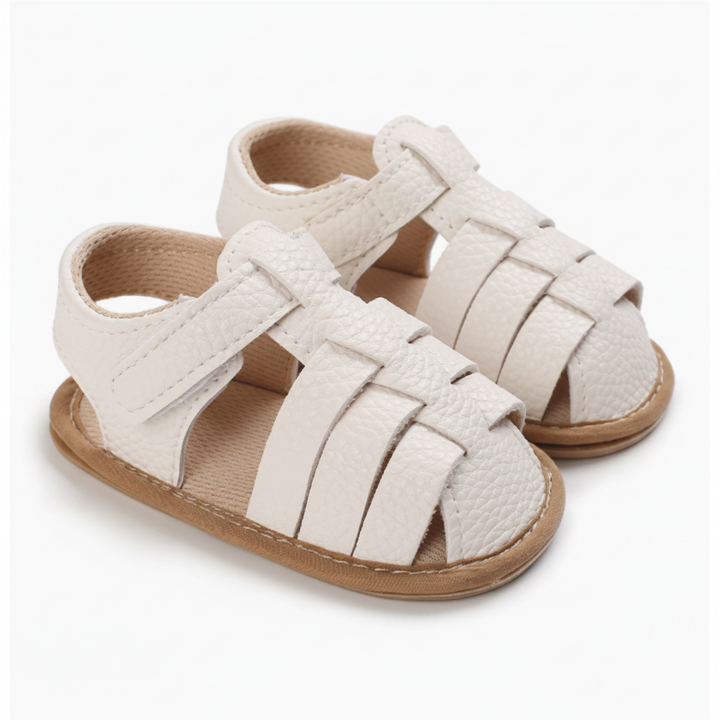 Pair of off-white closed-toe baby sandals with interwoven straps and ankle fastenings