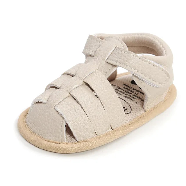 Off-white baby sandal with interwoven toe straps and a hook-and-loop ankle closure