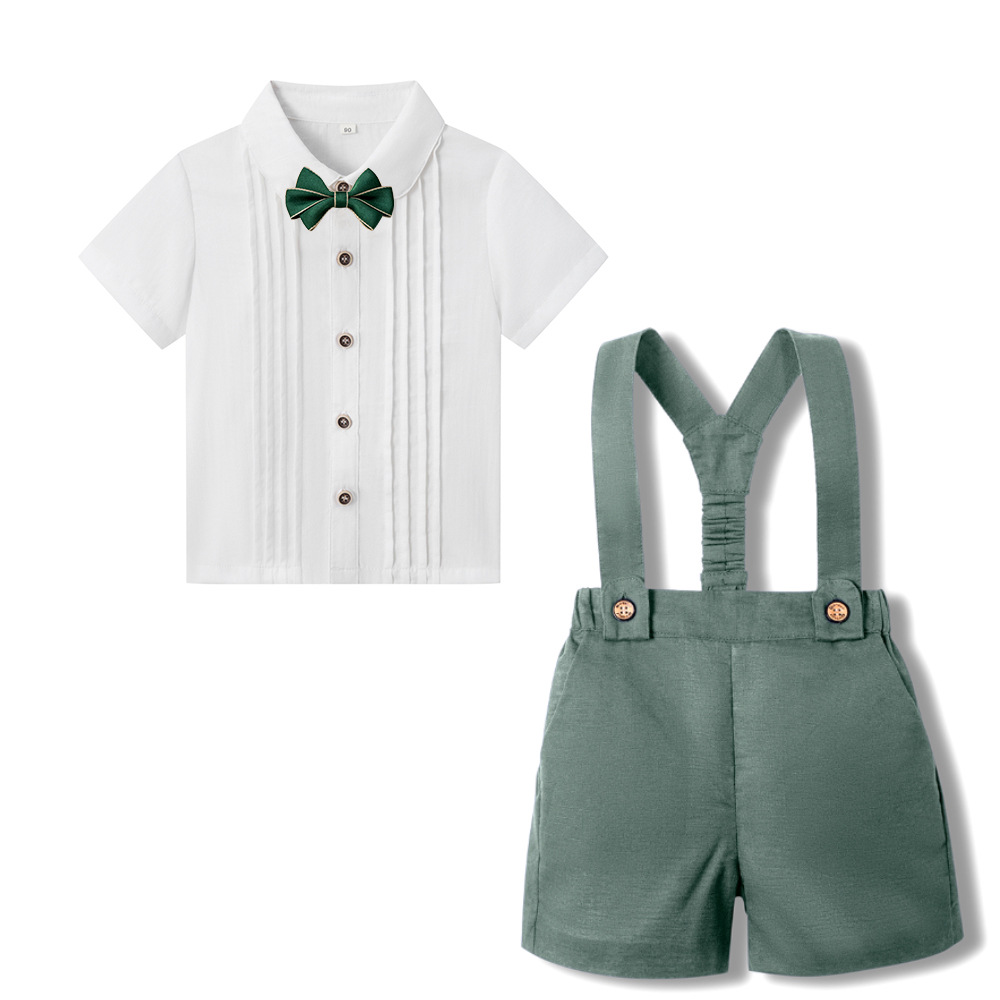 Olive green suspender shorts with a white short-sleeve shirt and green bow tie
