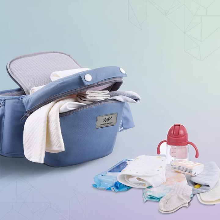 Blue hip seat with its storage compartment open beside a bottle, wipes, and diapers