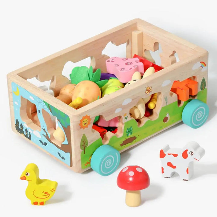 Open wooden farm wagon holding blocks, with a duck, mushroom, and cow beside it
