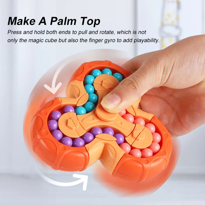 Hand holds the orange bead fidget puzzle at its center for finger-spinning play