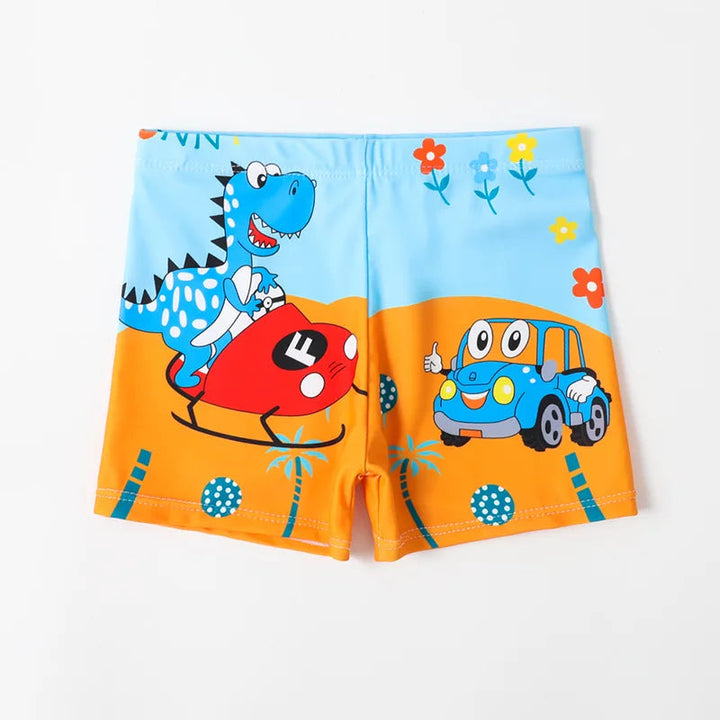 Blue and orange swim trunks with a cartoon dinosaur, red airplane, and blue bus.