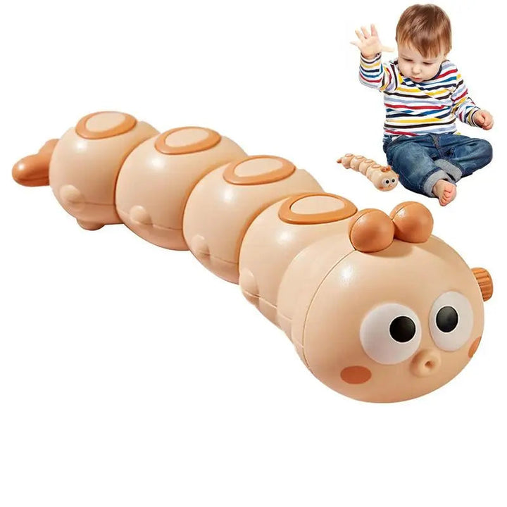Orange wind-up caterpillar toy with a segmented body and wide eyes, shown beside a child