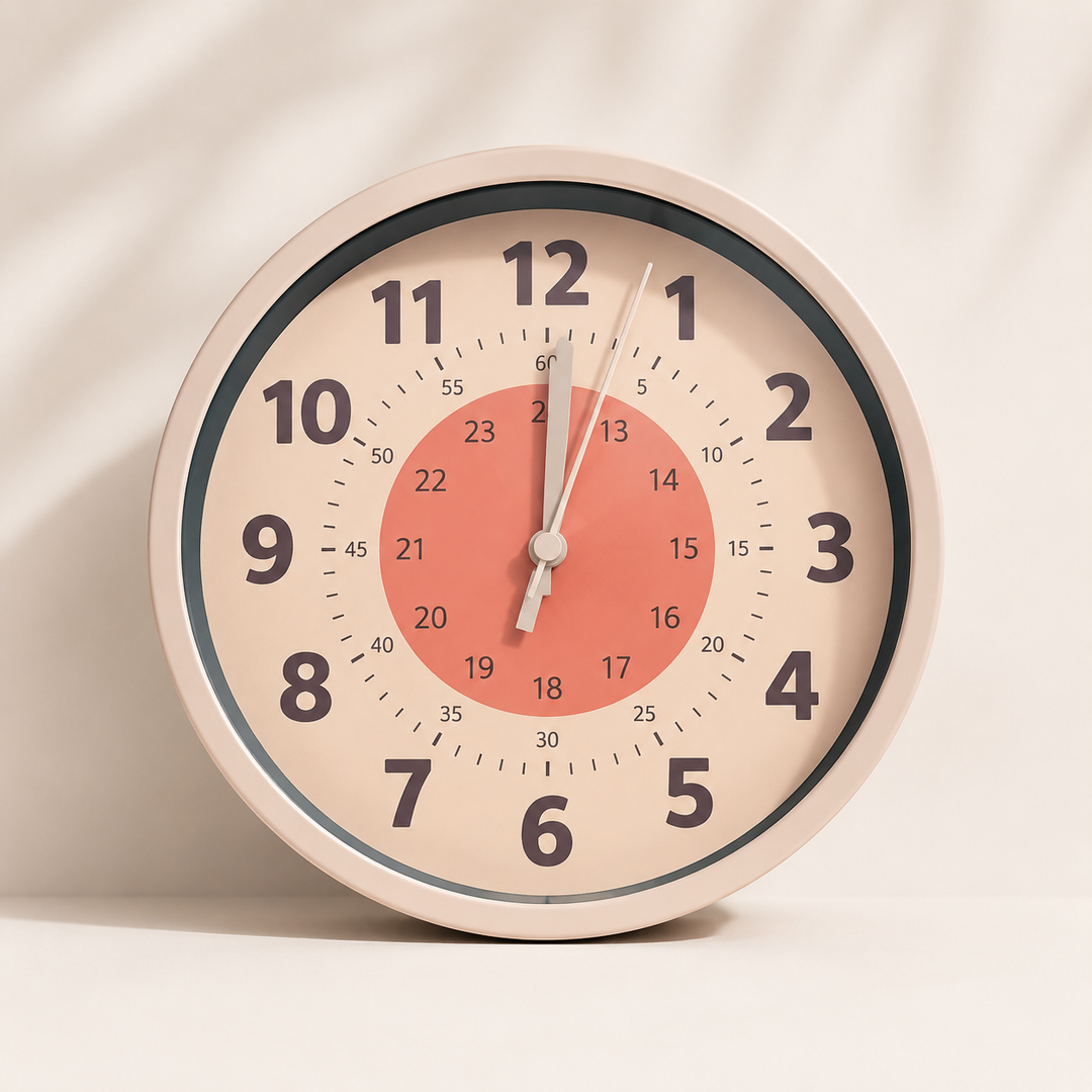 Orange-circle learning wall clock with black hour numbers and an inner 24-hour scale