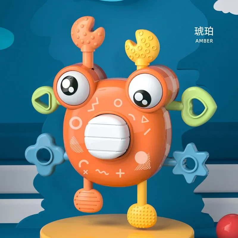 Orange crab sensory toy with textured claws, blue side shapes, and a white center button