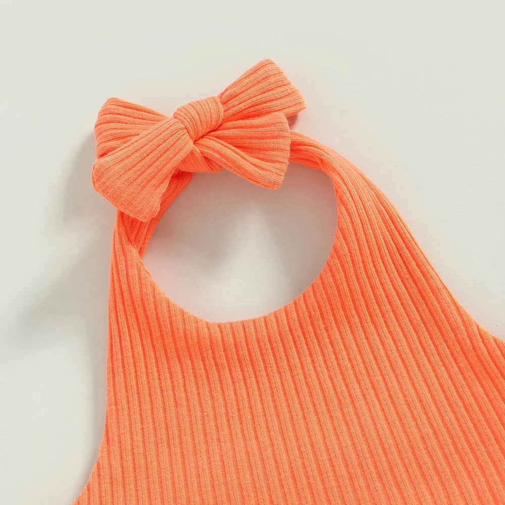 Close-up of an orange ribbed halter top with a bow at the neckline.