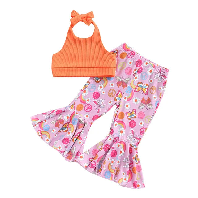 Orange halter top paired with pink flared pants featuring colorful retro prints.