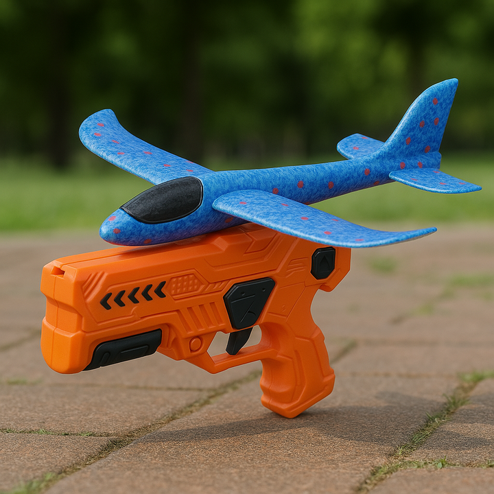 Orange launcher with black accents holding a blue foam airplane outdoors