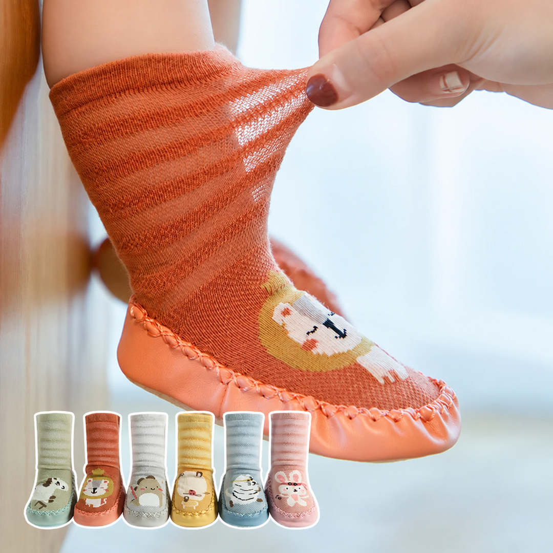 An orange lion sock shoe worn by a child, with the cuff being stretched