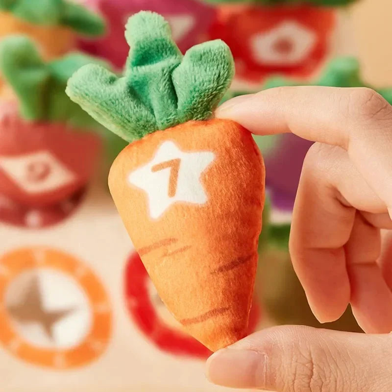 Hand holding an orange plush carrot marked with the number 7